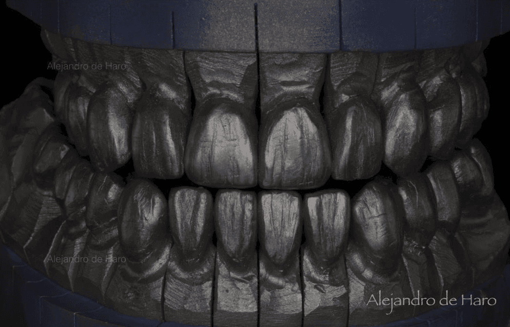 Close-up of a detailed carved wooden sculpture depicting human teeth and gums.